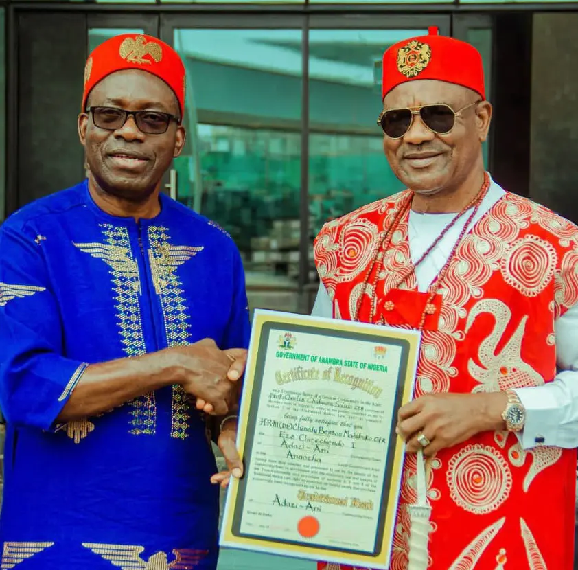 Two men presenting a framed recognition document